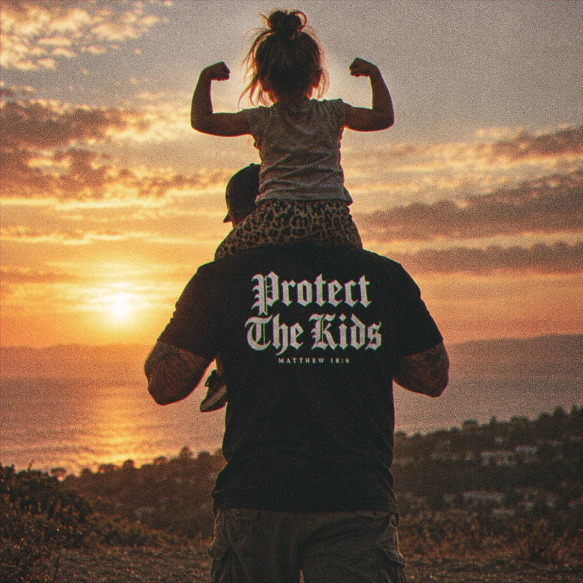 Father carrying daughter wearing Protect The Kids Matthew 18:6 Violent Community shirt